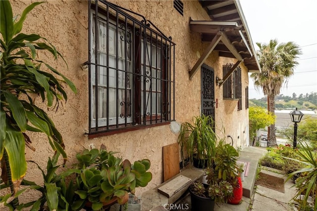 view of side of home with stucco siding