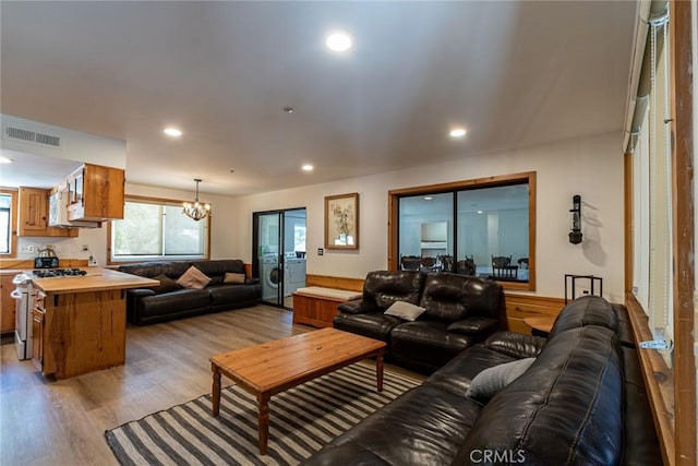 41505 Alder Dr, Forest Falls, CA 92339 - living room with a chandelier, washer / dryer, light wood finished floors, visible vents, and recessed lighting