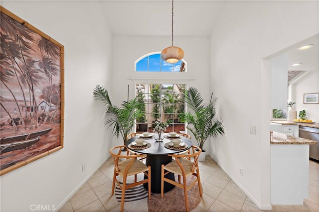 dining space featuring baseboards and light tile patterned floors
