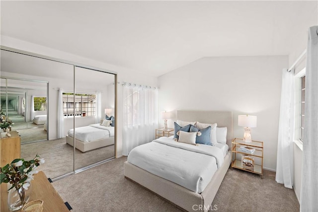 carpeted bedroom with vaulted ceiling and a closet