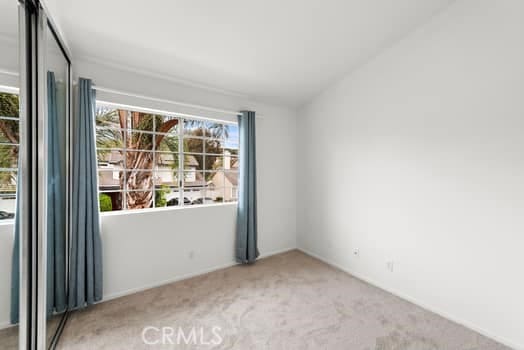spare room featuring carpet floors and a wealth of natural light