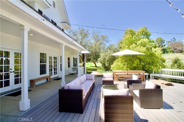 deck featuring outdoor lounge area and french doors