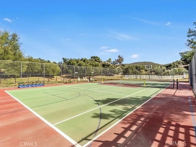 view of sport court with community basketball court and fence
