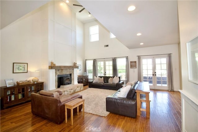 living area with high vaulted ceiling, wood finished floors, french doors, visible vents, and recessed lighting