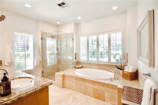 bathroom featuring recessed lighting, a shower stall, plenty of natural light, and a garden tub