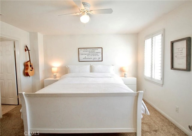 bedroom featuring ceiling fan, baseboards, and light colored carpet