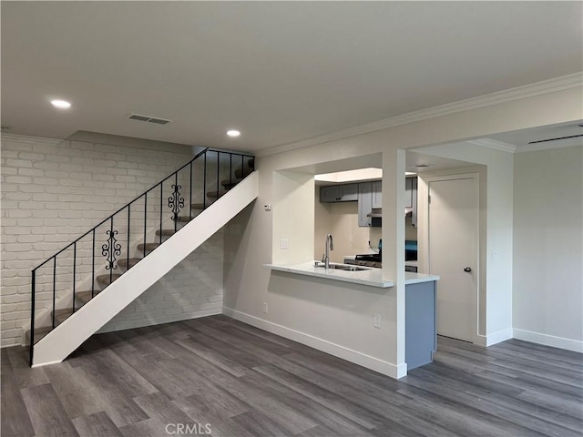 1709 Normandy Pl Unit B, Santa Ana, CA 92705 - stairs featuring brick wall, wood finished floors, ornamental molding, and recessed lighting