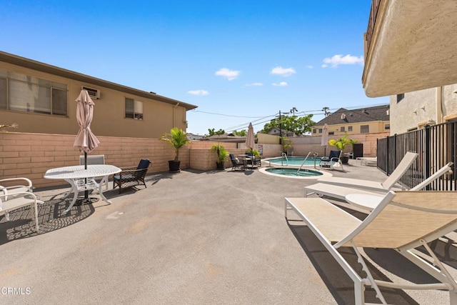view of patio featuring a fenced backyard and an in ground hot tub