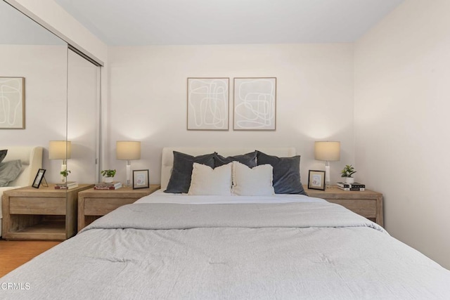 bedroom featuring wood finished floors and a closet