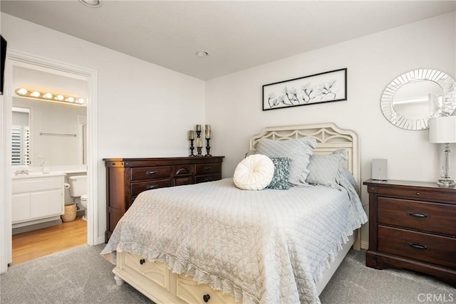 carpeted bedroom with recessed lighting and ensuite bath