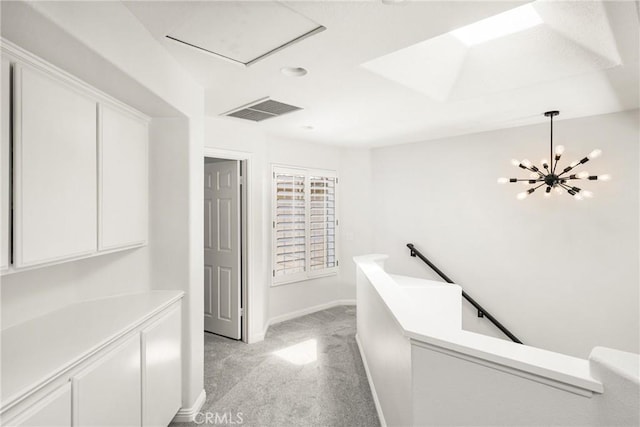 interior space featuring visible vents, light colored carpet, and an inviting chandelier