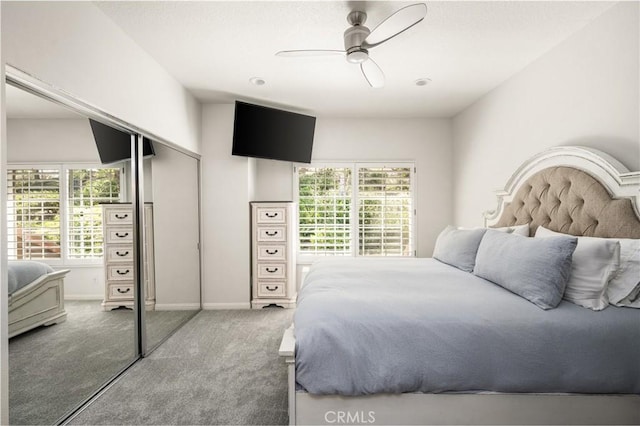 bedroom with carpet floors, a closet, a ceiling fan, and baseboards