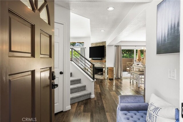 foyer featuring dark wood-style floors, recessed lighting, and stairway