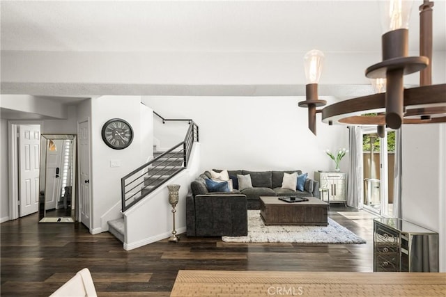 living area with baseboards, wood finished floors, and stairs