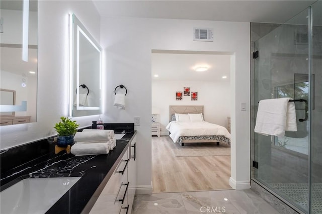 bathroom with baseboards, ensuite bath, a shower stall, and double vanity