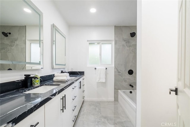 full bath featuring marble finish floor, a sink, double vanity, and recessed lighting
