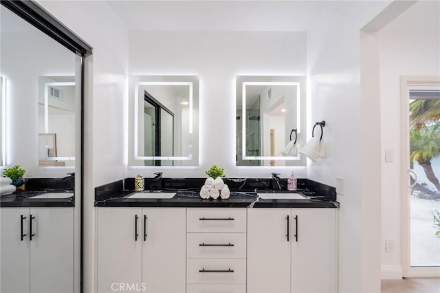 full bath with a sink and double vanity