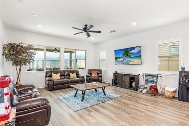 living area with visible vents, recessed lighting, ceiling fan, and wood finished floors
