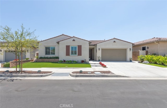 view of front facade featuring an attached garage, a tile roof, stucco siding, a front yard, and concrete driveway