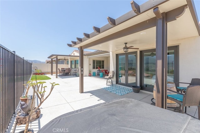 view of patio with a fenced backyard, ceiling fan, french doors, and outdoor dining space