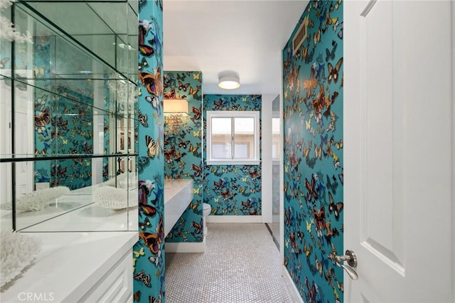 bathroom featuring tile patterned floors, wallpapered walls, vanity, and baseboards
