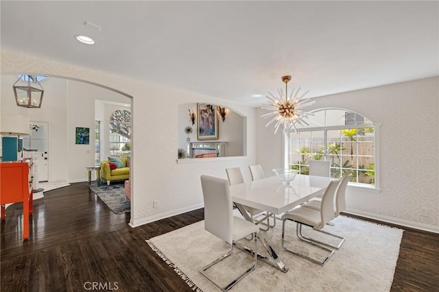 dining room with an inviting chandelier, wood finished floors, and baseboards
