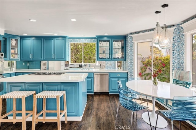 kitchen with blue cabinetry, a kitchen island, light countertops, dishwasher, and gas stovetop