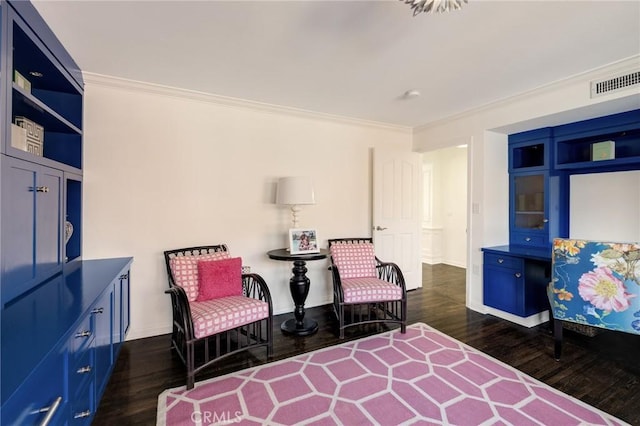 sitting room featuring dark wood-style flooring, visible vents, crown molding, and baseboards