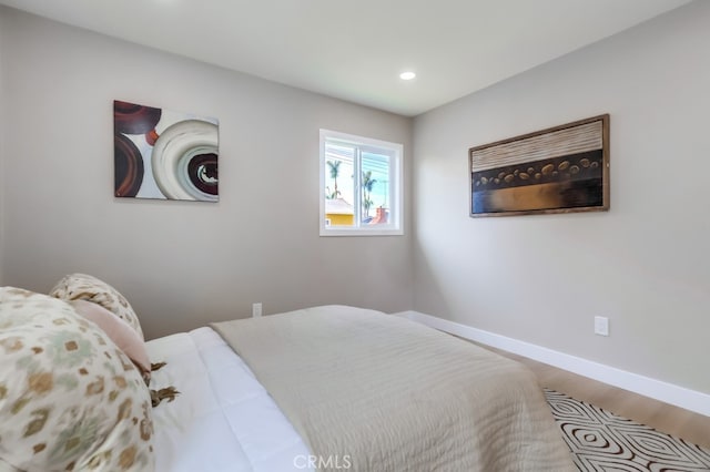 bedroom with baseboards, recessed lighting, and wood finished floors
