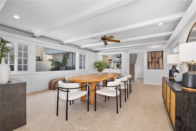 dining room with stairs, ceiling fan, light carpet, and beam ceiling