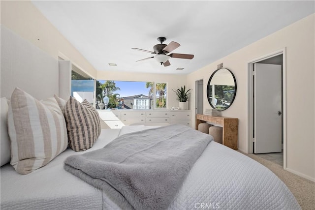 carpeted bedroom with visible vents and a ceiling fan