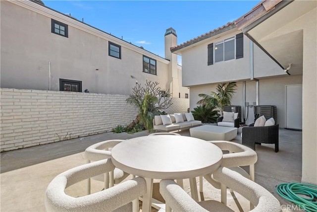view of patio with fence and outdoor dining space