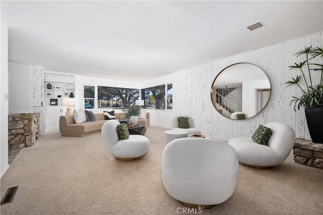 living area featuring carpet flooring and visible vents
