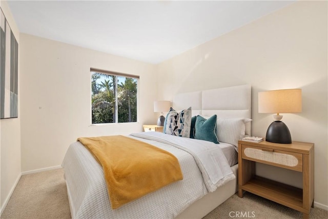 carpeted bedroom with baseboards