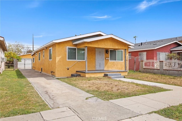bungalow-style home featuring a porch, stucco siding, a gate, fence, and a front yard