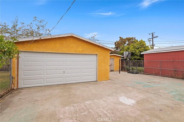 detached garage featuring fence