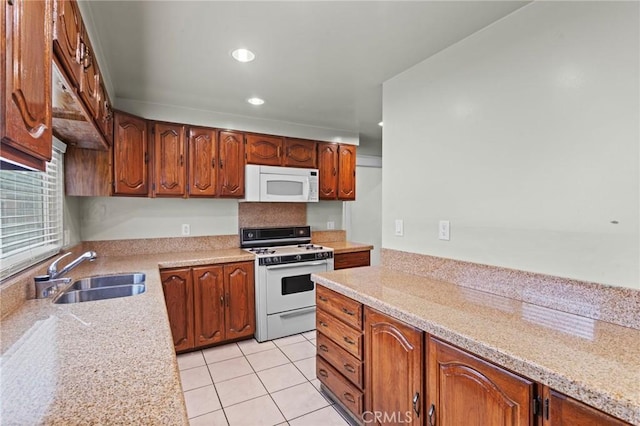 kitchen with light countertops, a sink, and white appliances