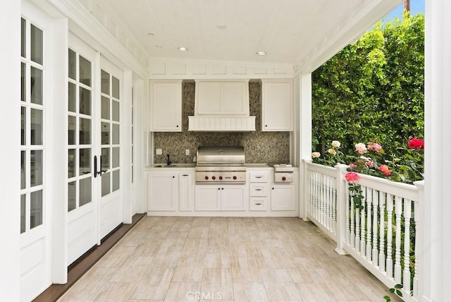 interior space with area for grilling, french doors, and exterior kitchen