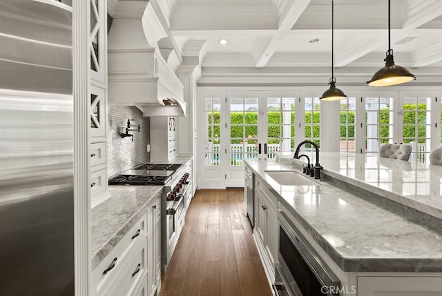 kitchen featuring coffered ceiling, dark wood-style flooring, premium appliances, a sink, and tasteful backsplash