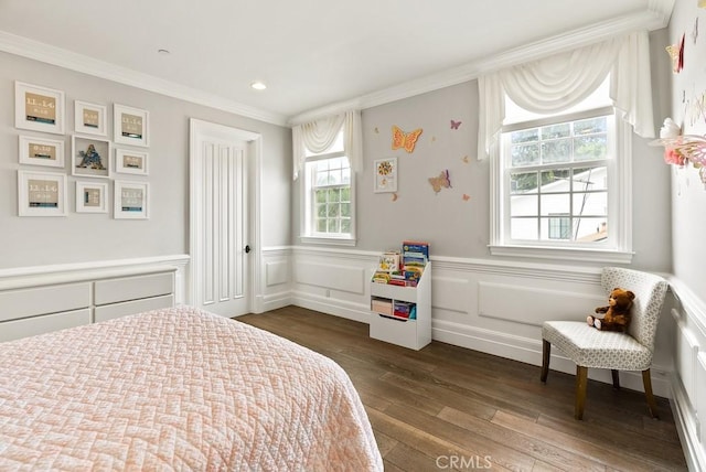 bedroom with crown molding, dark wood-style flooring, and wainscoting