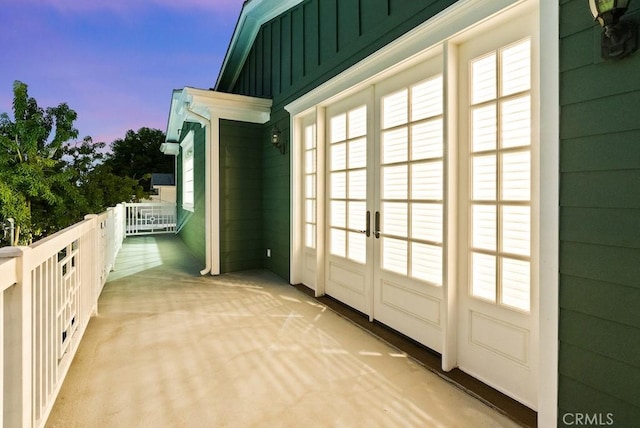 doorway featuring light carpet and french doors