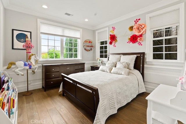 bedroom featuring wood-type flooring, visible vents, baseboards, ornamental molding, and recessed lighting