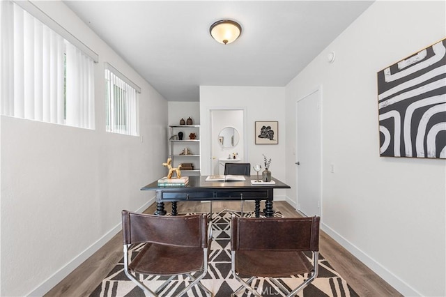 office with baseboards and wood finished floors
