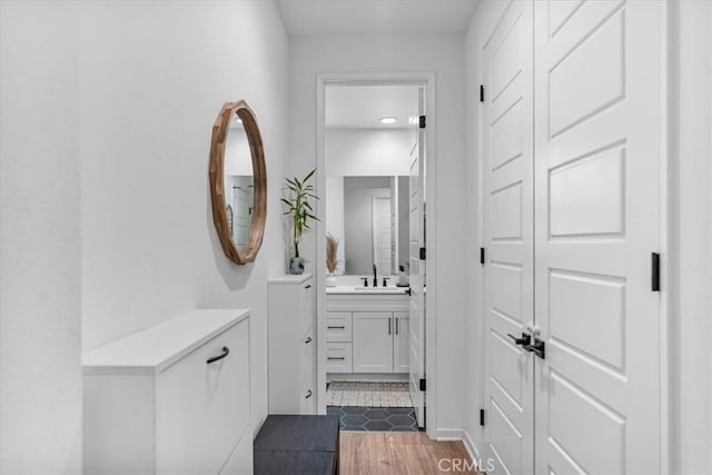 16452 Globetrotter Ave, Chino, CA 91708 - hallway with a sink and dark wood finished floors