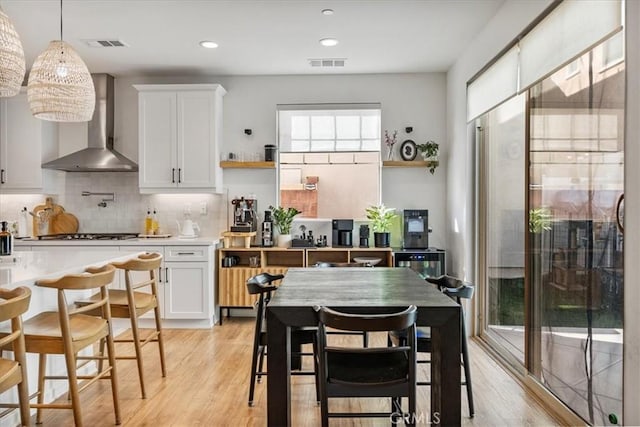 16452 Globetrotter Ave, Chino, CA 91708 - kitchen featuring open shelves, visible vents, light wood finished floors, and wall chimney exhaust hood
