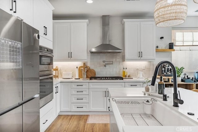 16452 Globetrotter Ave, Chino, CA 91708 - kitchen with a sink, wall chimney exhaust hood, appliances with stainless steel finishes, and light countertops
