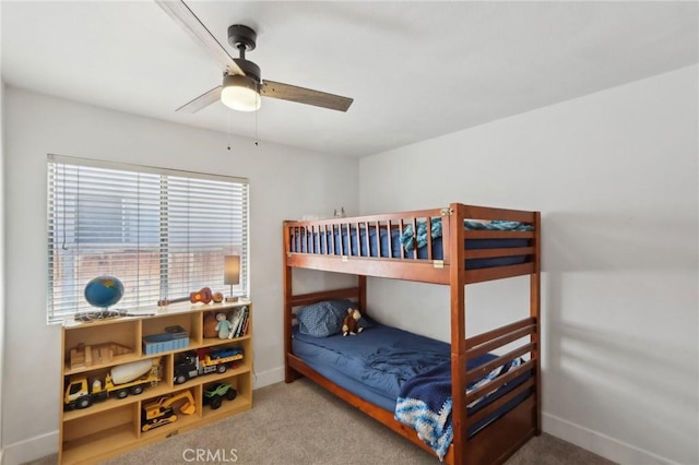carpeted bedroom featuring baseboards and ceiling fan