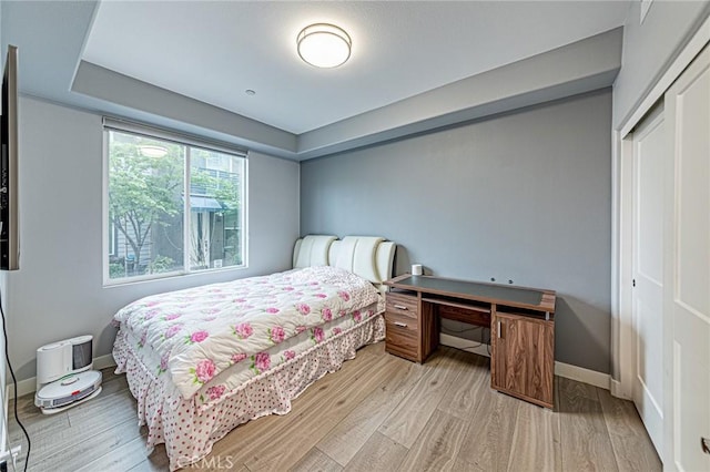 bedroom with baseboards and wood finished floors