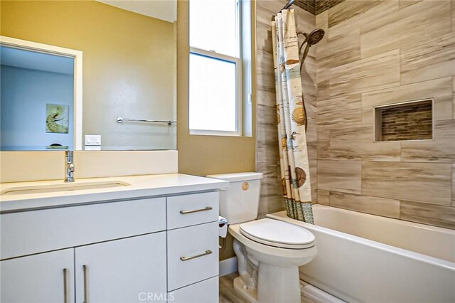 full bathroom featuring shower / bath combination with curtain, vanity, and toilet