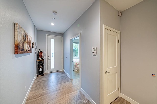 interior space featuring light wood-style flooring and baseboards